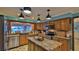 Spacious kitchen featuring stainless steel appliances, granite countertops, and wooden cabinets at 839 Fairway Dr, New Smyrna Beach, FL 32168