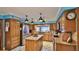 Kitchen with island, stainless steel appliances, wood cabinets, and patterned tile floor at 839 Fairway Dr, New Smyrna Beach, FL 32168