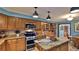 Kitchen features wood cabinets, granite countertops, stainless steel appliances, and an island at 839 Fairway Dr, New Smyrna Beach, FL 32168