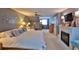Spacious main bedroom featuring a fireplace, king-size bed, and ample space for relaxation at 839 Fairway Dr, New Smyrna Beach, FL 32168