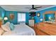 Main bedroom features teal walls, a king-size bed, and wooden furniture at 839 Fairway Dr, New Smyrna Beach, FL 32168