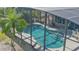 Screened in pool and patio with lush landscaping at 839 Fairway Dr, New Smyrna Beach, FL 32168