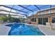 Inviting pool and spa with screened enclosure, overlooking golf course at 839 Fairway Dr, New Smyrna Beach, FL 32168