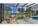 Relax by the pool with an outdoor grilling station at 839 Fairway Dr, New Smyrna Beach, FL 32168