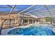 Screened-in pool and patio area with sitting area and grill at 839 Fairway Dr, New Smyrna Beach, FL 32168