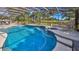 Screened pool and spa with adjacent grilling station at 839 Fairway Dr, New Smyrna Beach, FL 32168