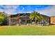 Enclosed pool and patio area with ample seating and lush landscaping at 839 Fairway Dr, New Smyrna Beach, FL 32168