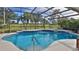 Inviting pool with a screen enclosure, overlooking a golf course at 839 Fairway Dr, New Smyrna Beach, FL 32168