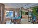 Sunroom with brick walls, tiled floor, dining table, and sliding doors to the living area at 839 Fairway Dr, New Smyrna Beach, FL 32168