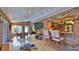 Sunroom with brick walls, tiled floor, dining area, and a bar overlooking the kitchen at 839 Fairway Dr, New Smyrna Beach, FL 32168