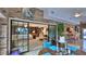 Sunroom with dining area, sliding doors to a living room or Gathering room, and brick accent wall at 839 Fairway Dr, New Smyrna Beach, FL 32168