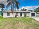 House exterior, featuring a newly painted facade and a dark gray garage door at 1806 Bayview Dr, New Smyrna Beach, FL 32168