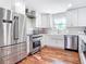 Modern kitchen with stainless steel appliances and white shaker cabinets at 1806 Bayview Dr, New Smyrna Beach, FL 32168