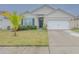 One-story house with a two-car garage and palm trees at 1911 Hollybrooke Rd, Edgewater, FL 32141