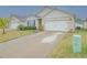 House exterior with a two-car garage and landscaping at 1911 Hollybrooke Rd, Edgewater, FL 32141