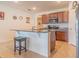 Kitchen island with granite countertop and dark brown cabinets at 1911 Hollybrooke Rd, Edgewater, FL 32141