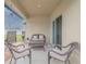 Covered patio with wicker furniture and a small table at 1911 Hollybrooke Rd, Edgewater, FL 32141