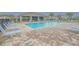 Community pool with lounge chairs and a covered patio at 1911 Hollybrooke Rd, Edgewater, FL 32141