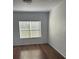 Bright bedroom with wood-look floors and large window at 827 Camargo Way # 307, Altamonte Springs, FL 32714