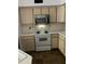 Kitchen with microwave and electric stove at 827 Camargo Way # 307, Altamonte Springs, FL 32714