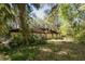 House with a large backyard surrounded by lush greenery at 5025 E Lake Mary Blvd, Sanford, FL 32771