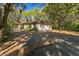 Single-story home with driveway and mature trees at 5025 E Lake Mary Blvd, Sanford, FL 32771