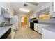 Kitchen with white cabinets, black appliances, and tile floor at 5025 E Lake Mary Blvd, Sanford, FL 32771