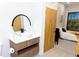 Modern bathroom with a stylish vanity, circular mirror, and patterned tile shower at 4849 W Irlo Bronson Hwy # 409, Kissimmee, FL 34746