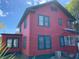 Two-story red house with green trim and multiple windows at 415 Braddock Ave, Daytona Beach, FL 32118