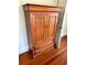 Wooden armoire with double doors and drawers at 415 Braddock Ave, Daytona Beach, FL 32118