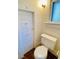Small bathroom with toilet and door at 415 Braddock Ave, Daytona Beach, FL 32118