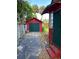 Red garage with green doors and a cracked driveway at 415 Braddock Ave, Daytona Beach, FL 32118