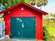 Detached red garage with green double doors at 415 Braddock Ave, Daytona Beach, FL 32118
