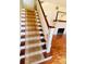 Classic wooden staircase with a runner carpet at 415 Braddock Ave, Daytona Beach, FL 32118