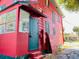 Red house with green door and screened porch at 415 Braddock Ave, Daytona Beach, FL 32118