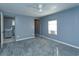 Spacious bedroom with carpet, ceiling fan, and ensuite bathroom access at 14650 Liberty St, Orlando, FL 32826
