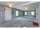 Open living room with carpeted floor, neutral walls, and ceiling fans at 14650 Liberty St, Orlando, FL 32826
