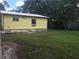 Large backyard with grassy area behind the house at 14650 Liberty St, Orlando, FL 32826