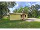 Yellow house exterior with a spacious yard at 14650 Liberty St, Orlando, FL 32826