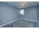 Bright bedroom featuring carpet flooring and a window with blinds at 14650 Liberty St, Orlando, FL 32826
