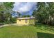 Side view of the house with a large yard at 14650 Liberty St, Orlando, FL 32826