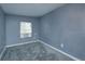 Small bedroom with gray walls and carpet at 14650 Liberty St, Orlando, FL 32826