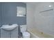 Updated bathroom features a vanity, toilet, and bathtub at 14650 Liberty St, Orlando, FL 32826