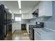 Modern kitchen with white cabinets, granite countertops, and black appliances at 14650 Liberty St, Orlando, FL 32826