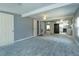 Open living room with carpeted floor, neutral walls, and ceiling fans at 14650 Liberty St, Orlando, FL 32826