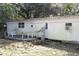 White mobile home with green algae and a wooden deck at 770 Snow Hill Rd, Geneva, FL 32732