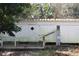 White mobile home with a wooden deck and water heater at 770 Snow Hill Rd, Geneva, FL 32732