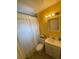 Bathroom with yellow walls and a white vanity at 1023 W Gore W St, Orlando, FL 32805