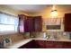 Functional kitchen with granite countertops and dark wood cabinets at 1023 W Gore W St, Orlando, FL 32805