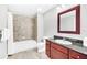 Well-appointed bathroom with a tub, shower, and dark wood vanity at 14501 Grove Resort Ave # 1430, Winter Garden, FL 34787